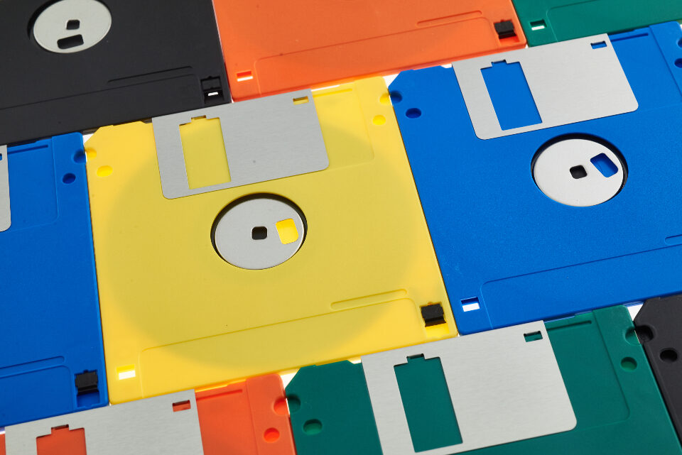 Legacy systems stack of coloured floppy disks
